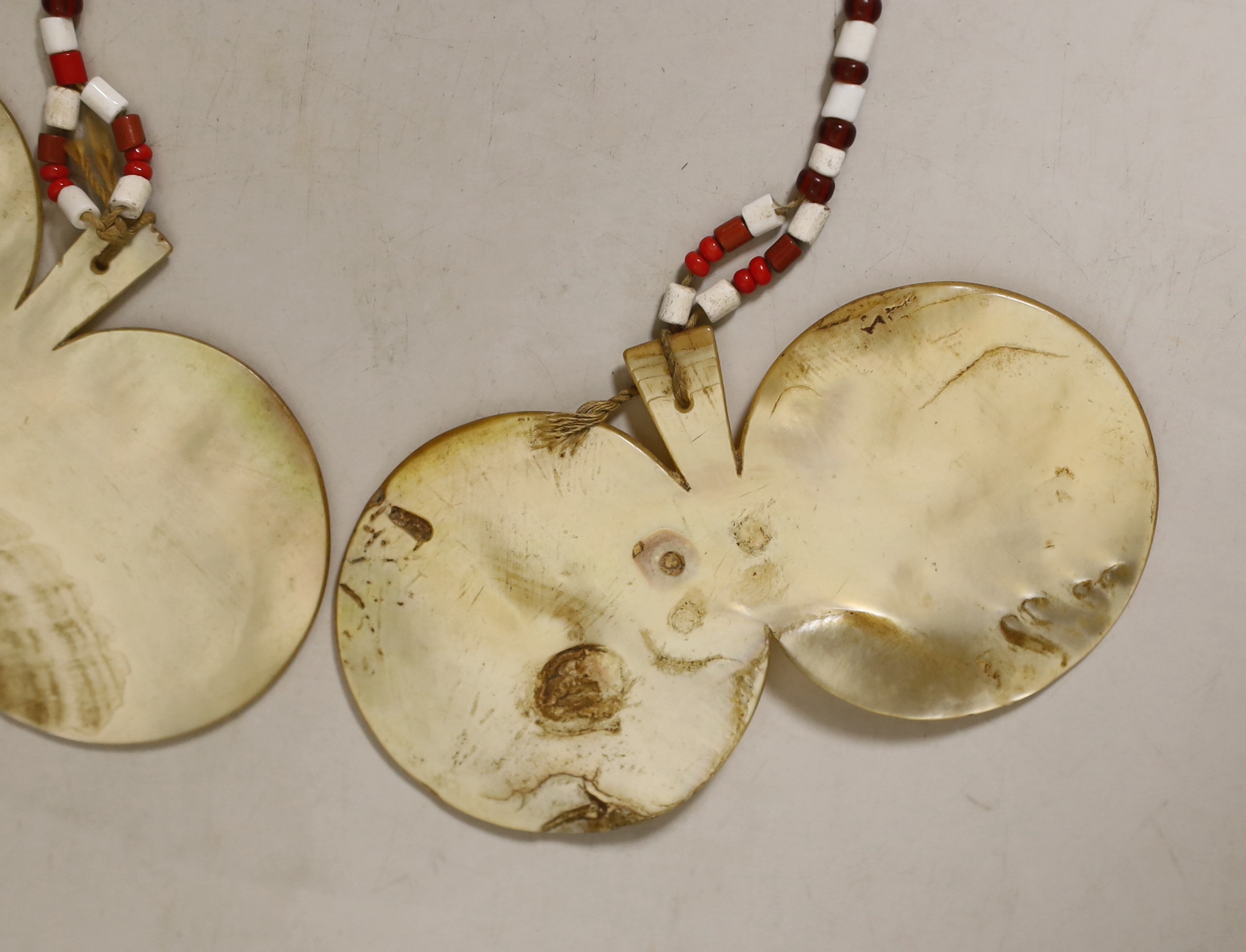 A pair of Philippines mother of pearl bawisak earrings, Naga tribe, each 11.5cm. Provenance – a European Private collection, thence by family descent. Ethnographica from the same collection was sold by Sotheby’s, Paris,